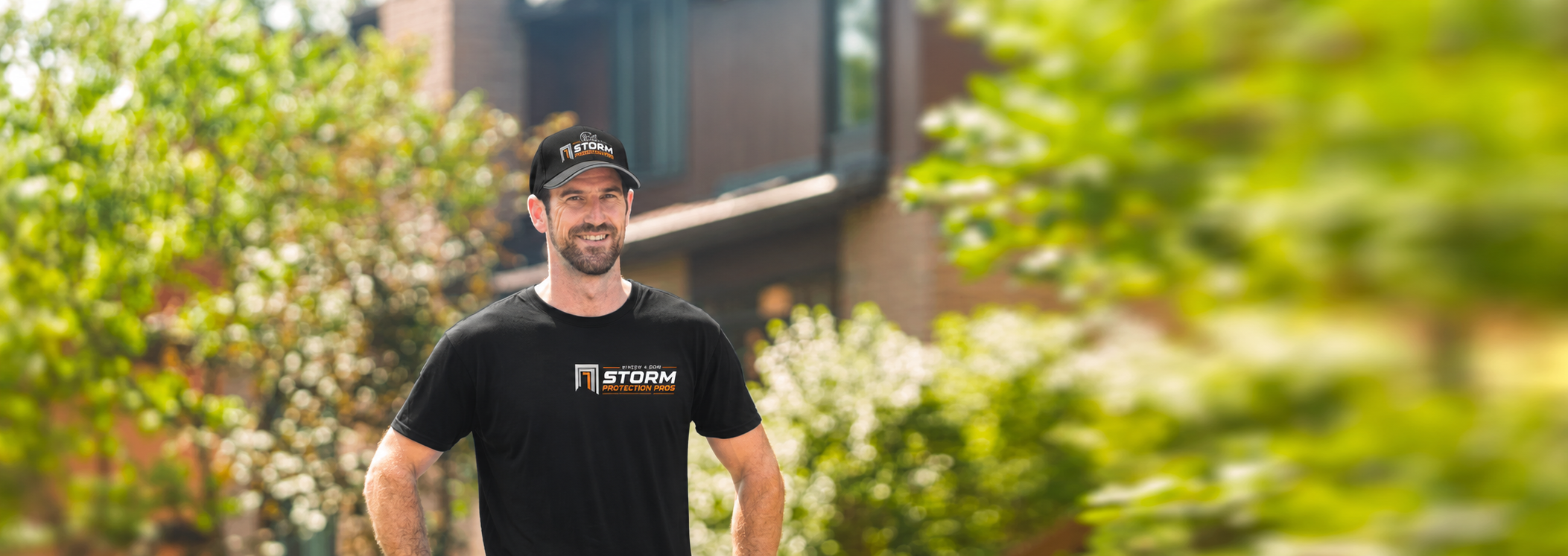 A Storm Protection Pros window installer poses in front of a Sarasota, Florida home.
